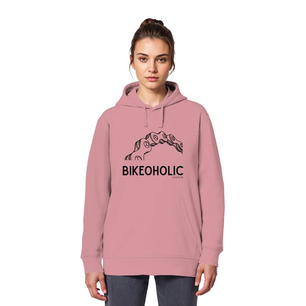 Weibliches Model trägt rosa Fahrrad Hoodie unisex mit stylischer Fahrradkette und Bikeoholic Schriftzug