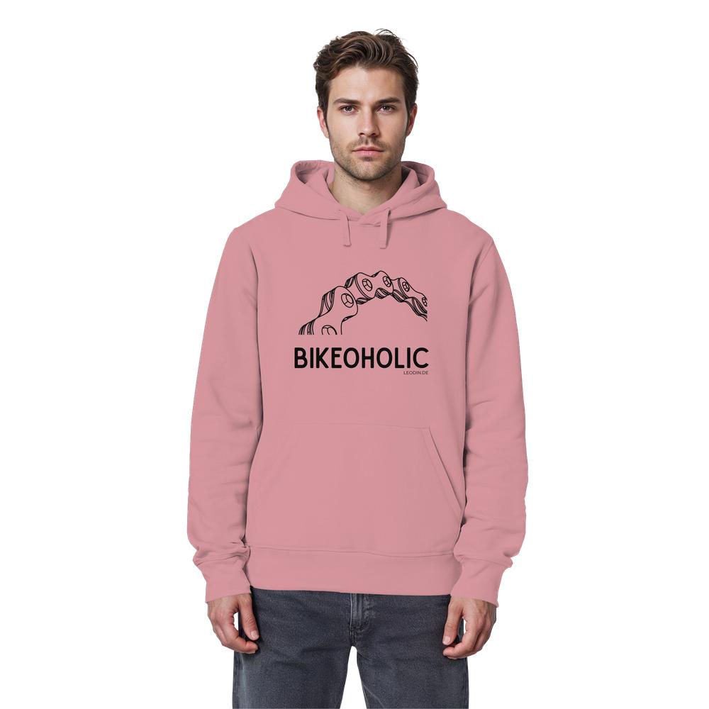Männliches Model trägt rosa Fahrrad Hoodie unisex mit stylischer Fahrradkette und Bikeoholic Schriftzug