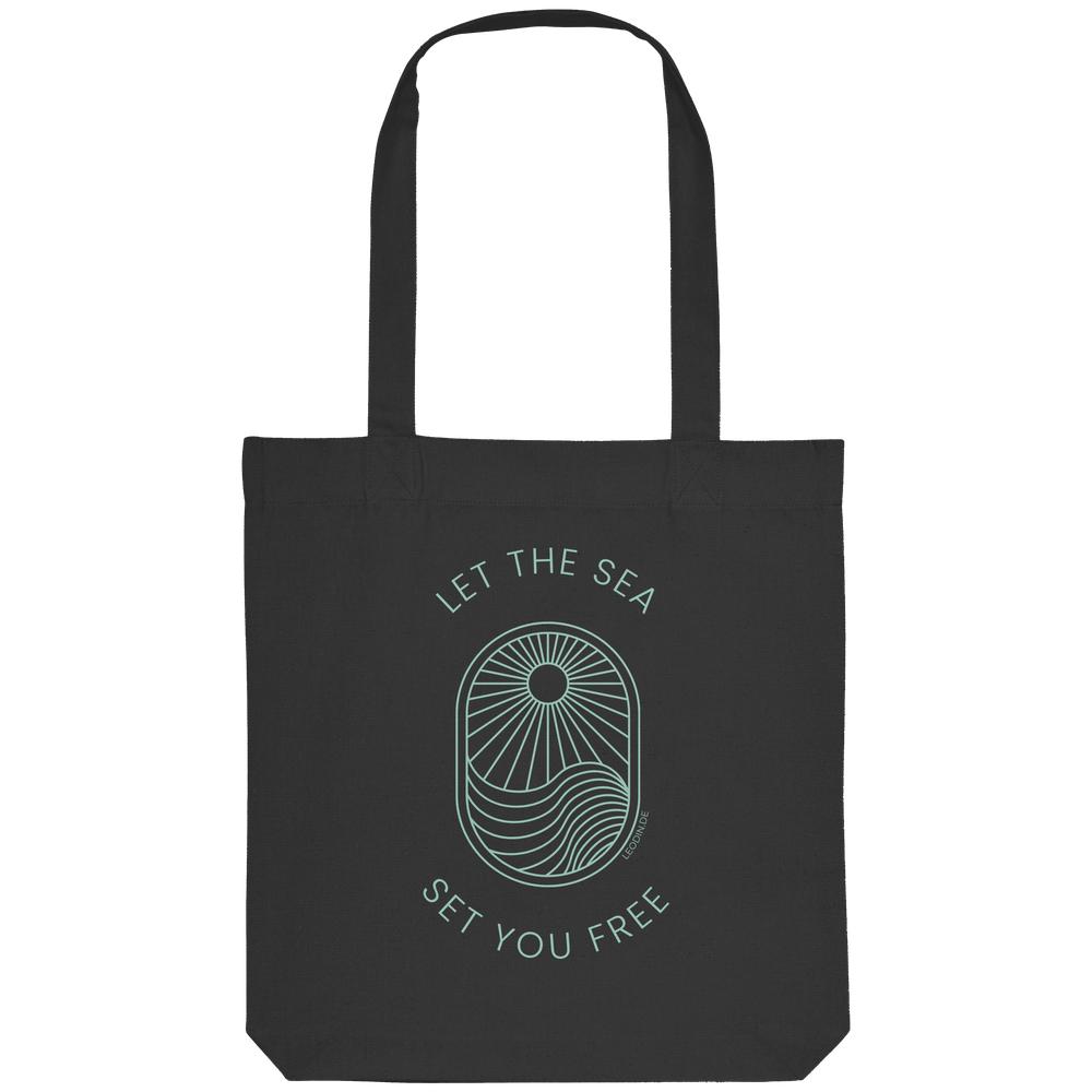 Schwarze Tote Bag mit Let the Sea Set You Free Wellenmotiv