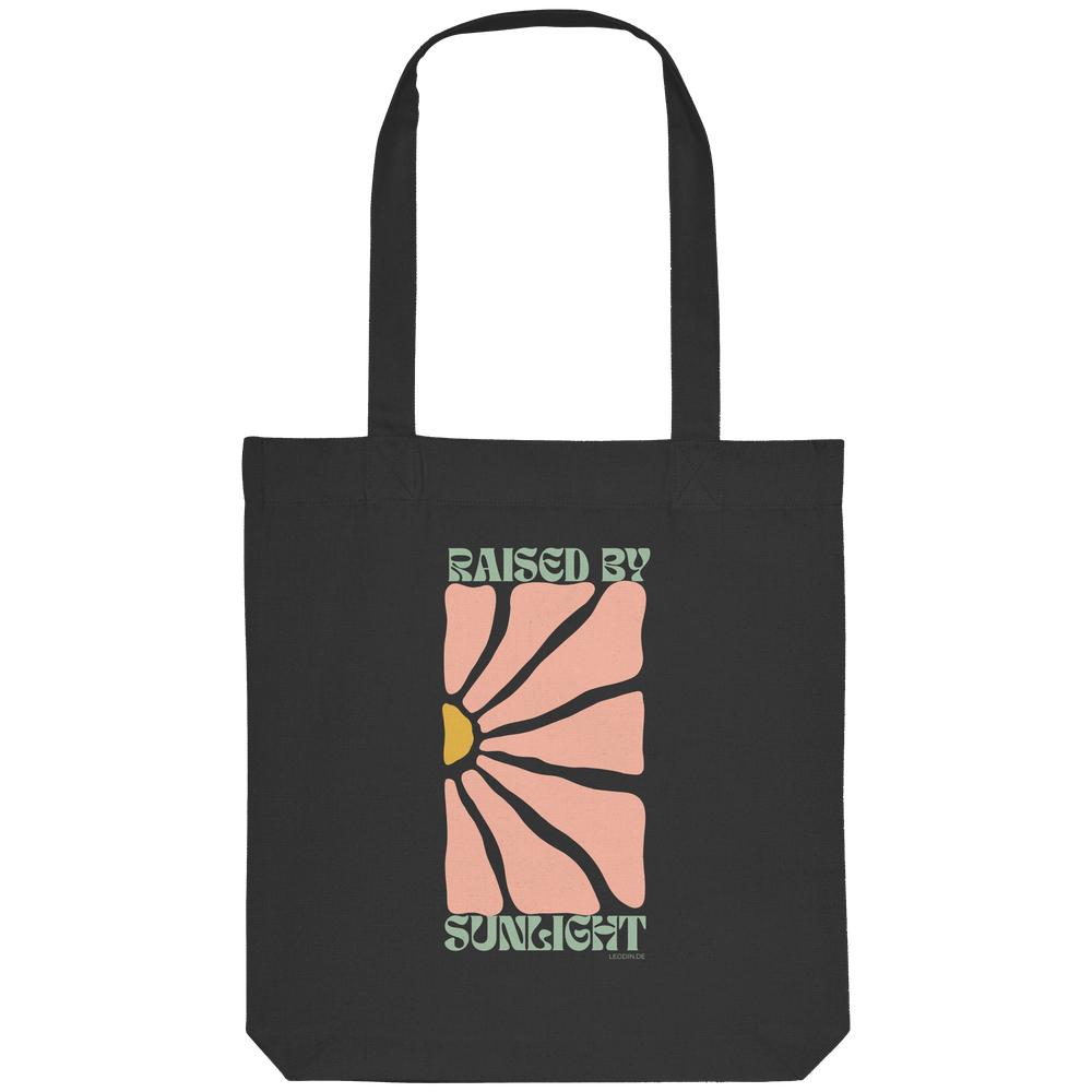 Schwarze Organic Tote Bag mit Raised by Sunlight Motiv