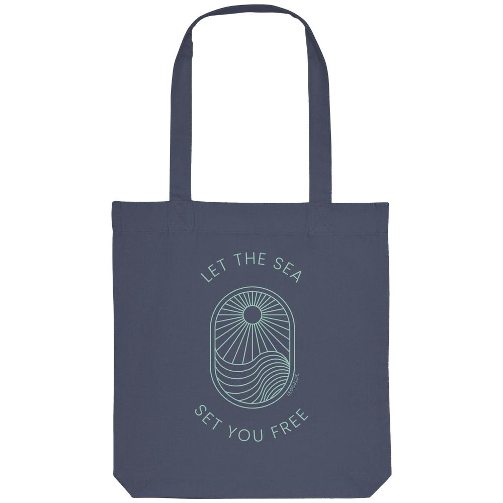 Dunkelblaue Tote Bag mit Let the Sea Set You Free Wellenmotiv